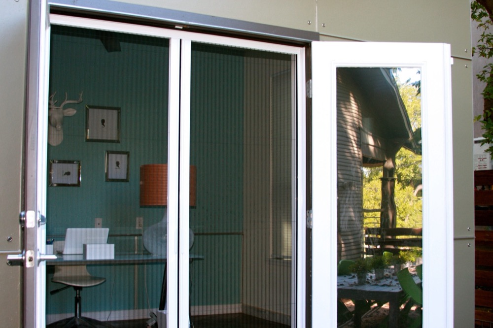 Pleated screen drawn across a pair of French doors