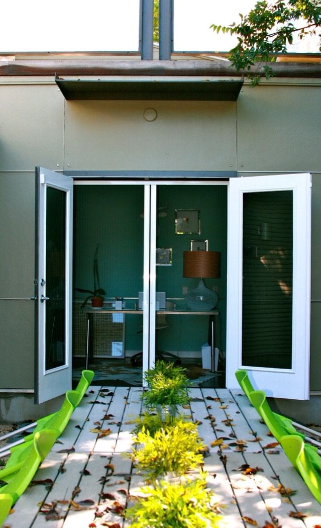 Open French doors onto a patio with the pleated screens fully retracted
