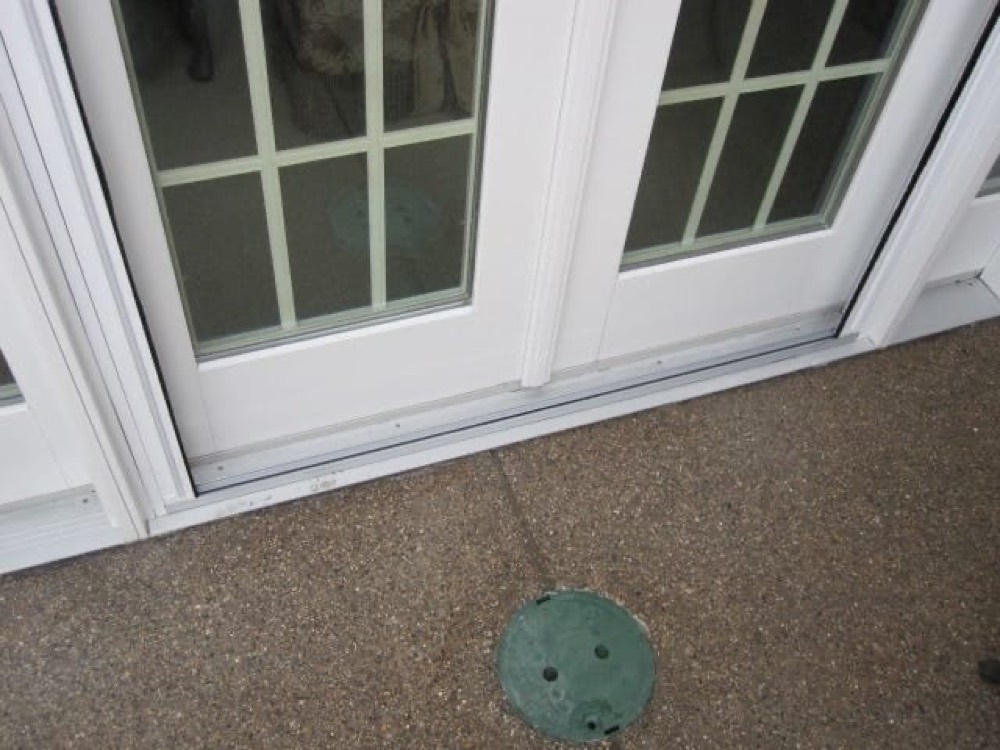 Close-up of the retracted pleated screen and the flat bottom rail at the door threshold