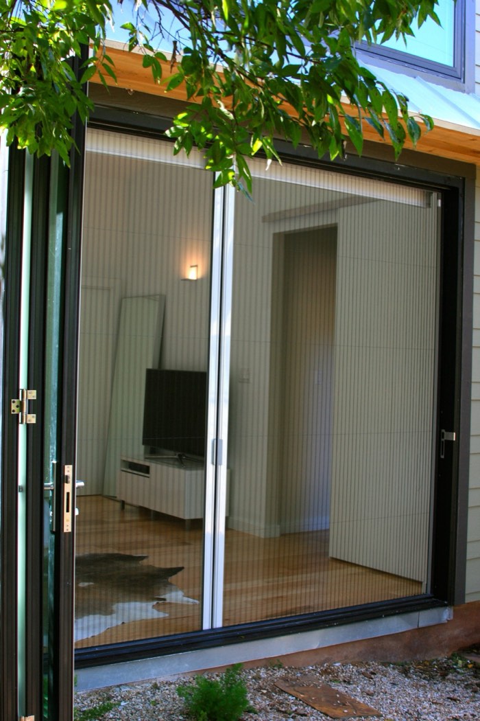 Interior view of a door with the pleated screen folded away at the side