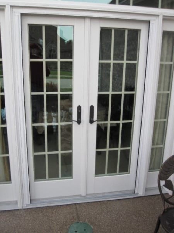 Double French doors with both pleated screen halves fully stowed against the jambs